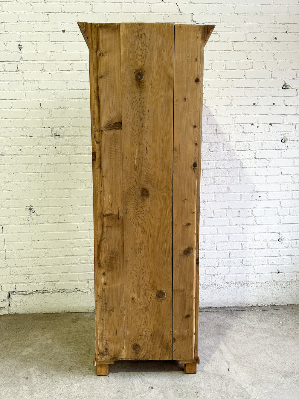 A Tall and Narrow Antique Pine European Cupboard with Bottom Drawer c. 1900