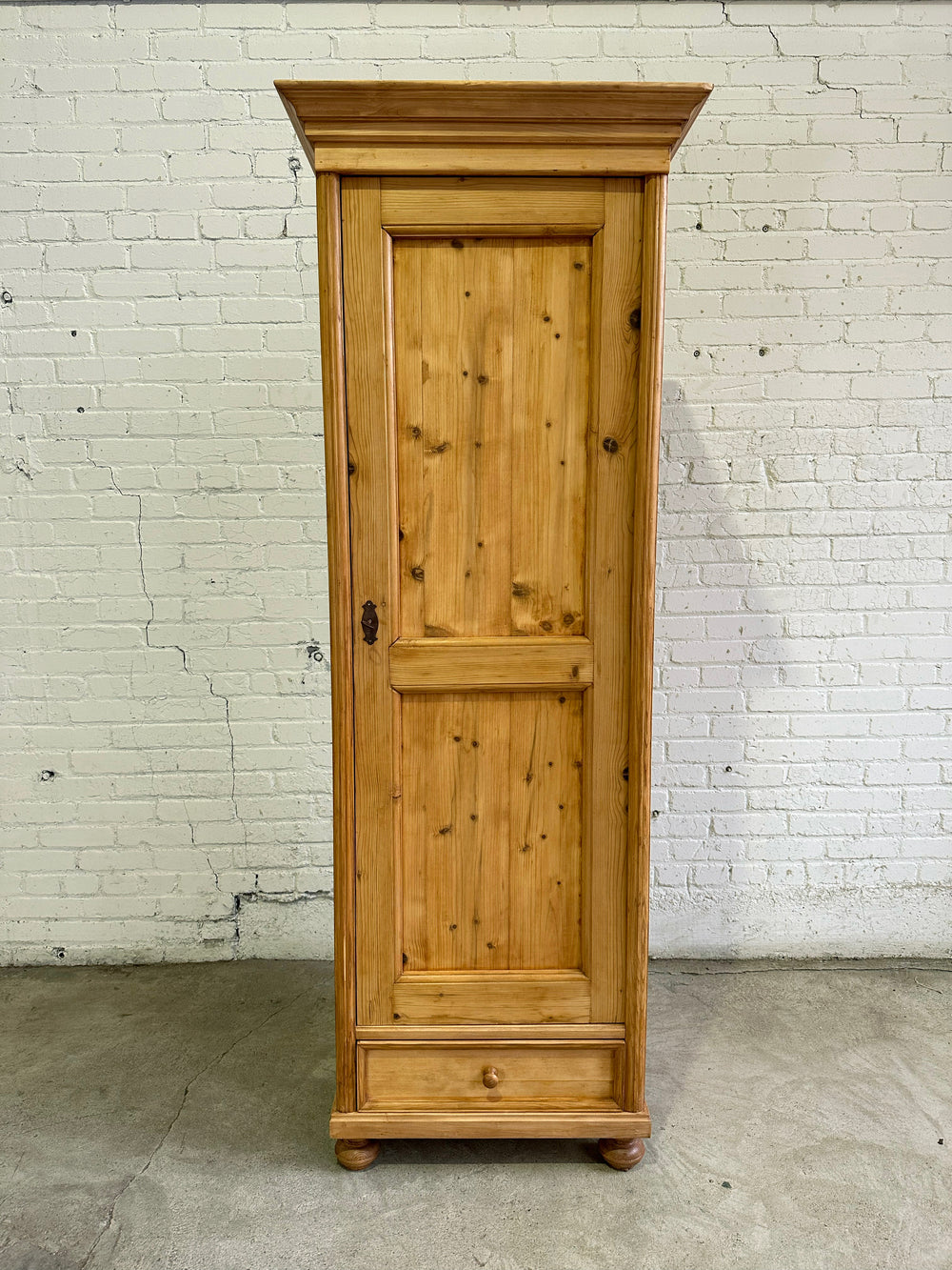 A Tall and Narrow Antique Pine European Cupboard with Bottom Drawer c. 1900