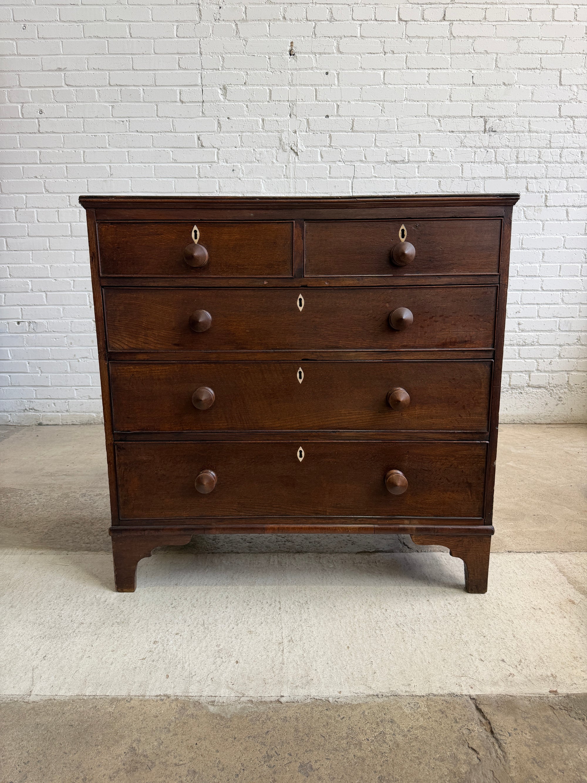 An Antique Oak English Chest of Drawers on Bracket Feet c. 1820