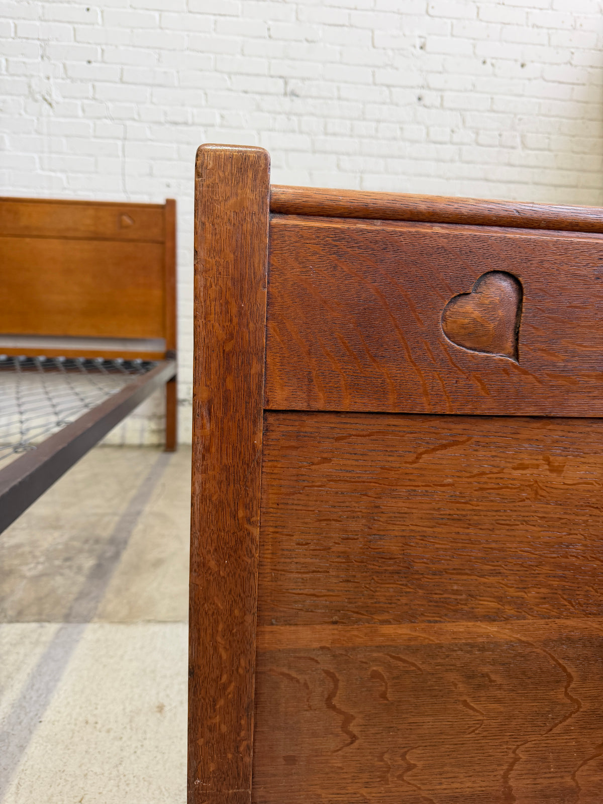 A Pair of Edwardian Heart Motif Beds by Liberty of London
