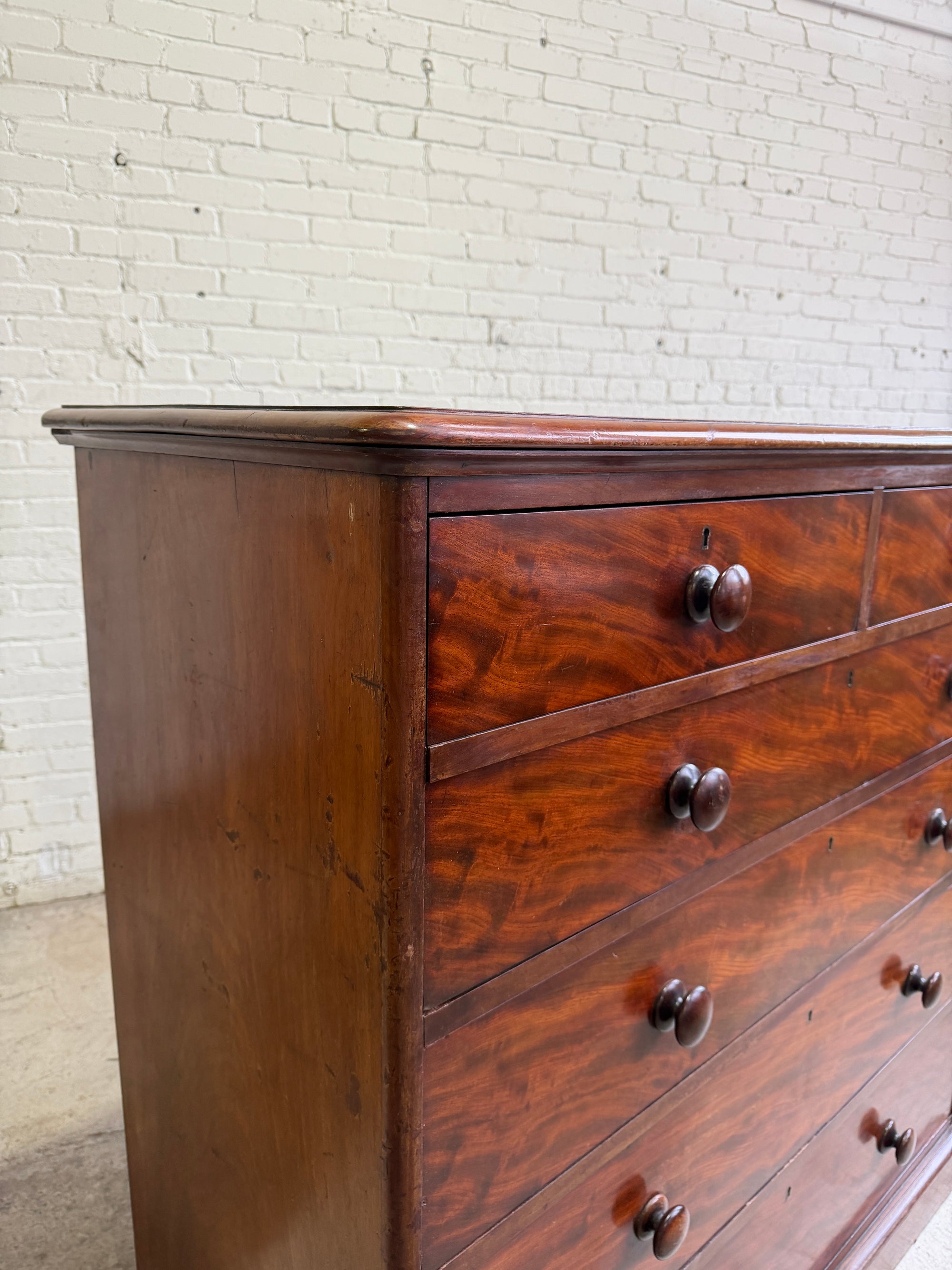 An Antique English Flame Mahogany Chest of Drawers c.1860
